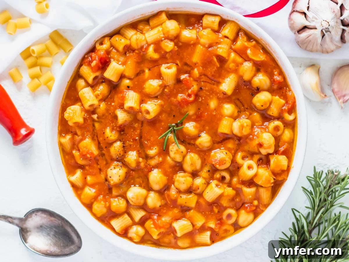 30 Simple Soup Solutions 9 Pasta e Ceci recipe in a white bowl with fresh rosemary garnish