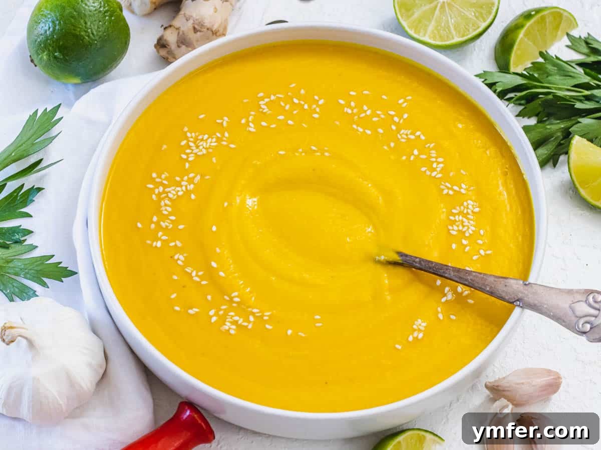 30 Simple Soup Solutions 11 Kabocha squash soup in a white bowl, garnished with fresh herbs