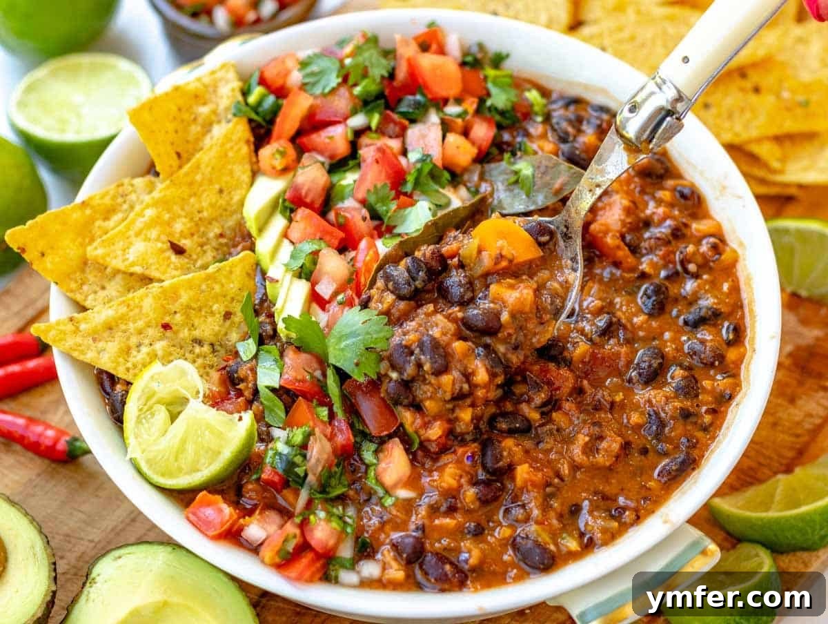 30 Simple Soup Solutions 20 Black bean soup with various fresh toppings and a spoon