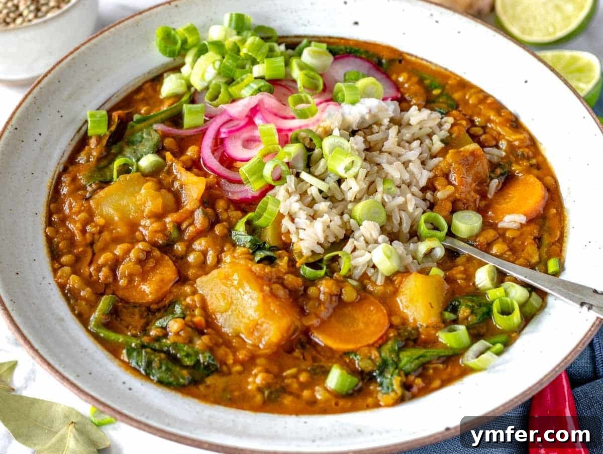30 Simple Soup Solutions 22 Curry lentil soup in a bowl, garnished with fresh herbs