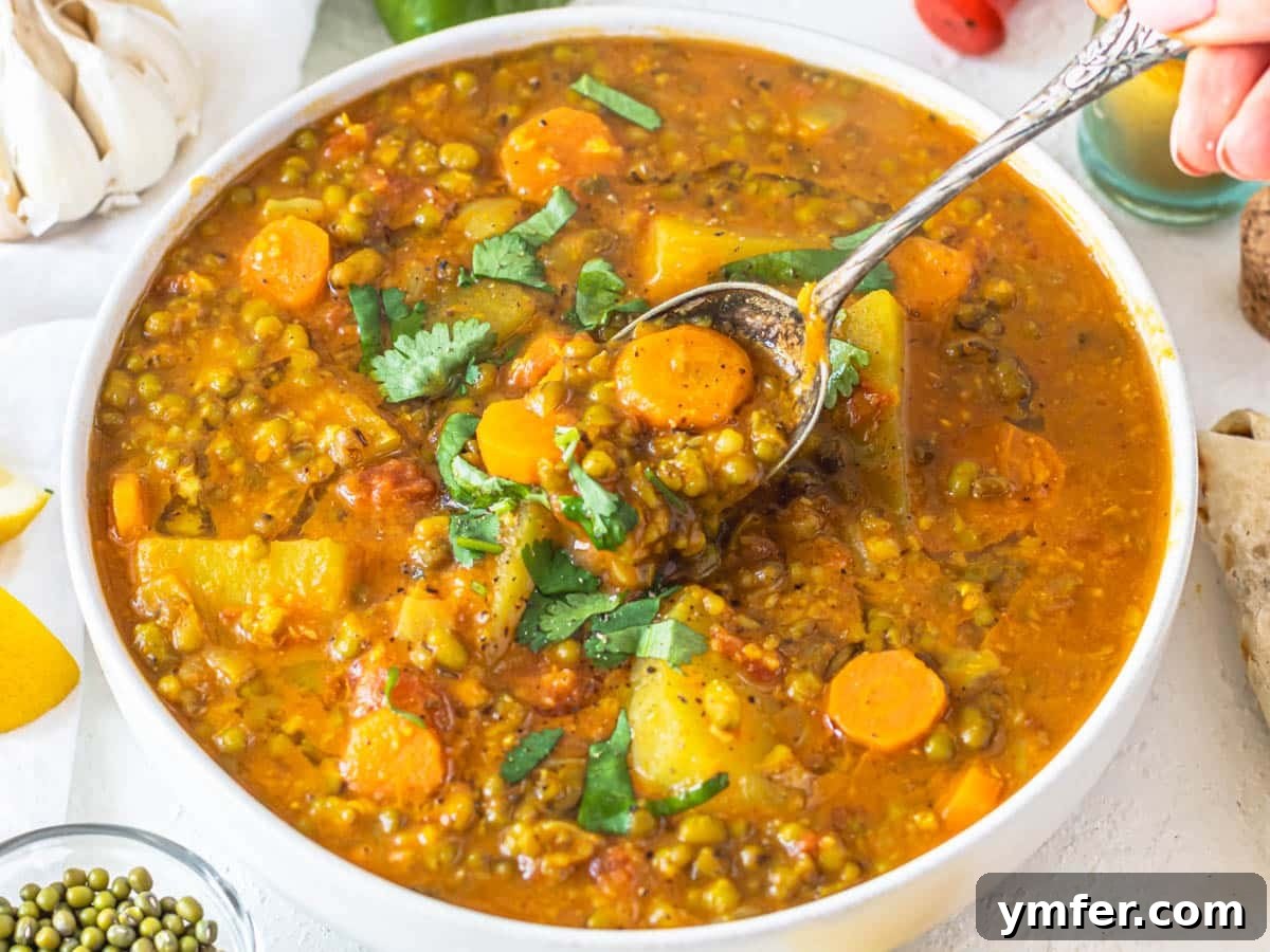 30 Simple Soup Solutions 23 Mung bean soup with a silver spoon and fresh cilantro garnish
