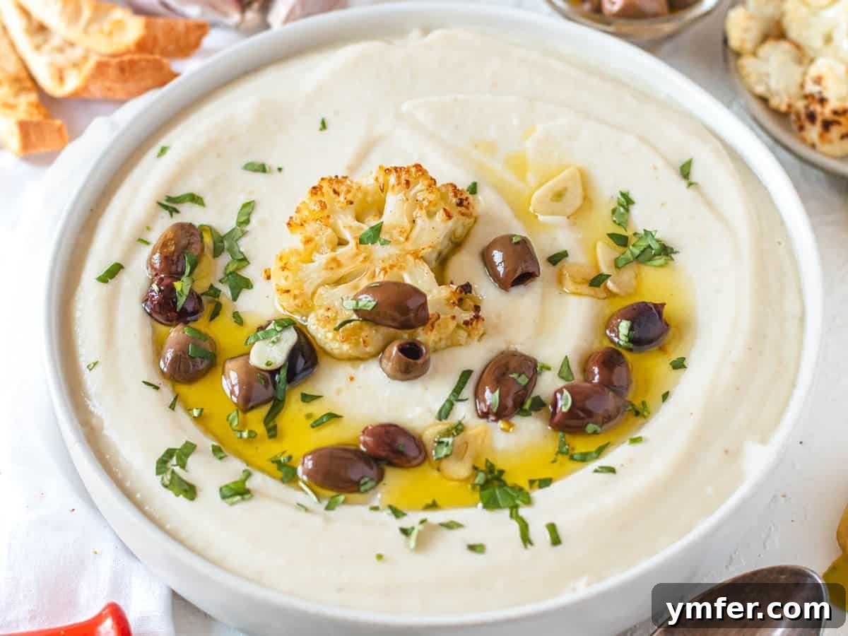 30 Simple Soup Solutions 4 Cauliflower soup drizzled with extra virgin olive oil and roasted cauliflower florets in a white bowl