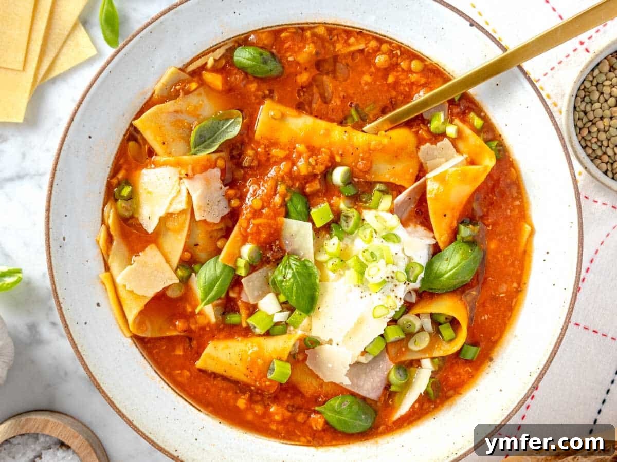 30 Simple Soup Solutions 28 Lasagna soup in a bowl topped with ricotta, parmesan, and fresh basil