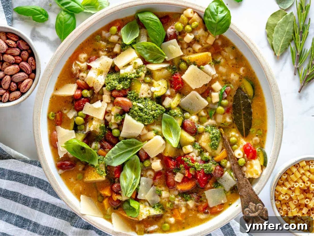 30 Simple Soup Solutions 6 Minestrone soup in a bowl, topped with pesto, parmesan, and fresh basil