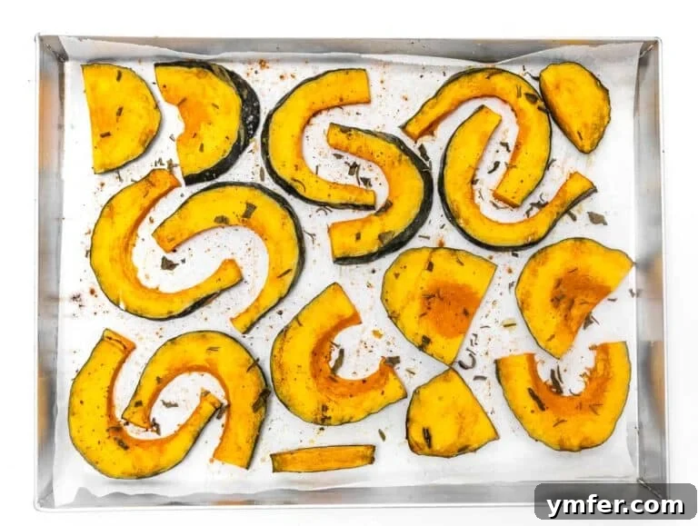 Golden Roasted Kabocha 9 Perfectly roasted kabocha squash wedges, golden brown and glistening, with a fork gently piercing one to show its tenderness.