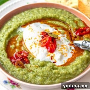 Broccoli soup with burrata cheese and a spoon