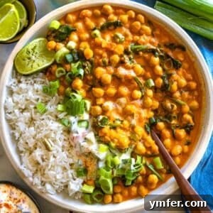 Creamy Coconut Chickpea Curry 8 Creamy chickpea curry recipe with a spoon and rice.
