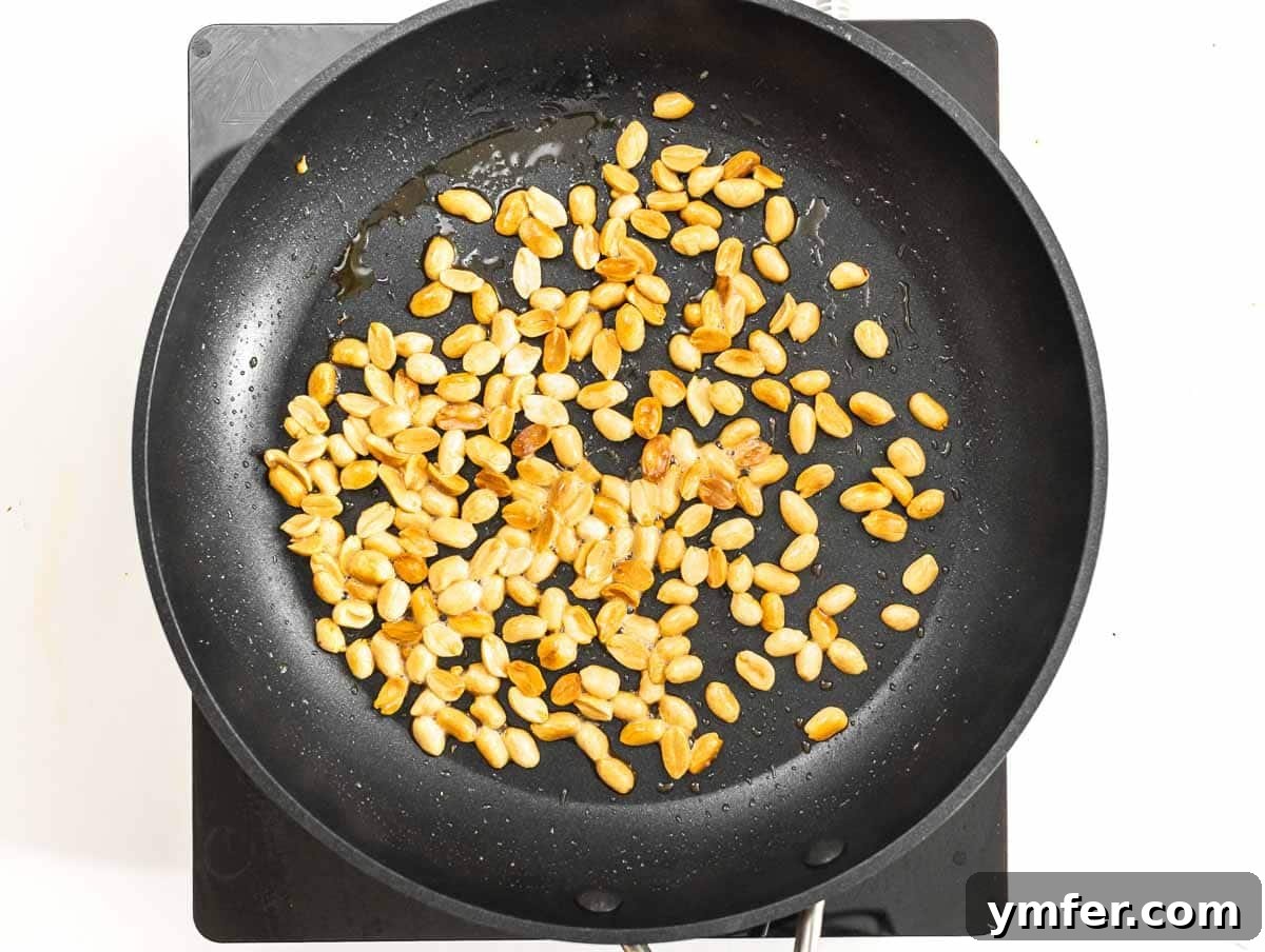 Kung Pao Tofu 7 Peanuts gently frying in a non-stick pan.