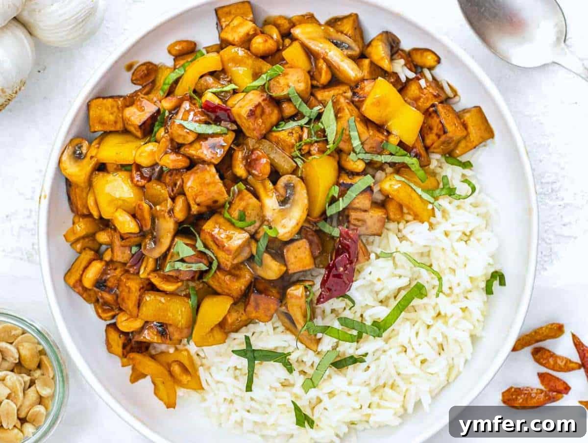 Kung Pao Tofu 10 Finished Kung Pao Tofu served with basil and rice, ready to eat.
