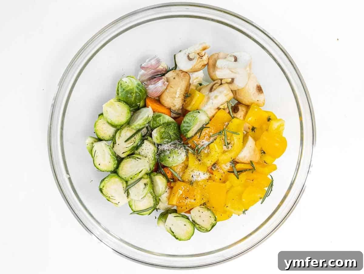Sheet Pan Roasted Delights 6 Chopped vegetables tossed in a mixing bowl with olive oil, herbs, and spices