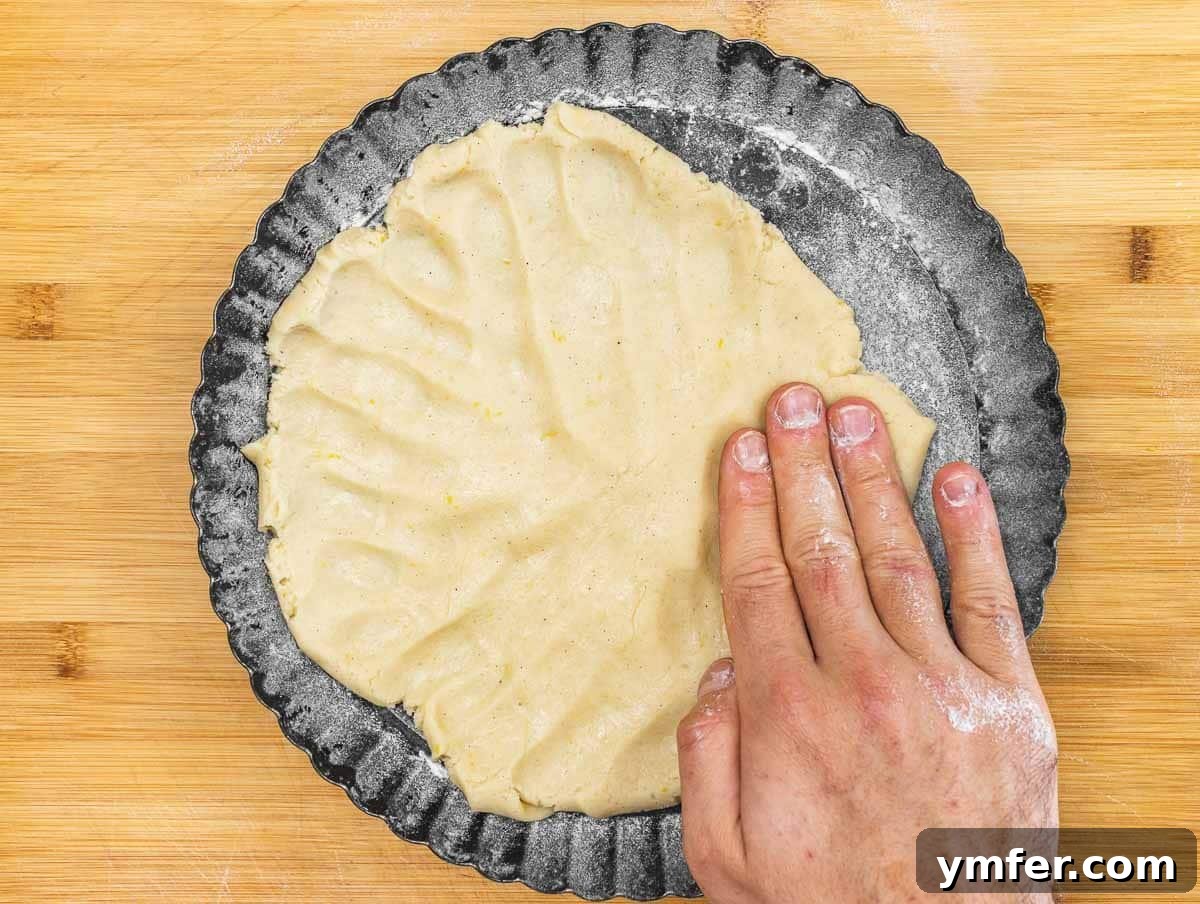 pie crust in the cake pan, flattened by hand