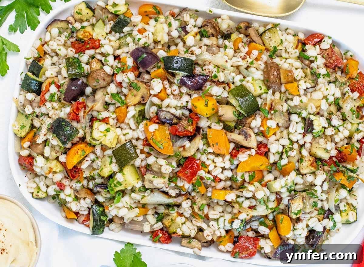 Hearty Barley Salad 5 Barley salad on a platter with a side of hummus