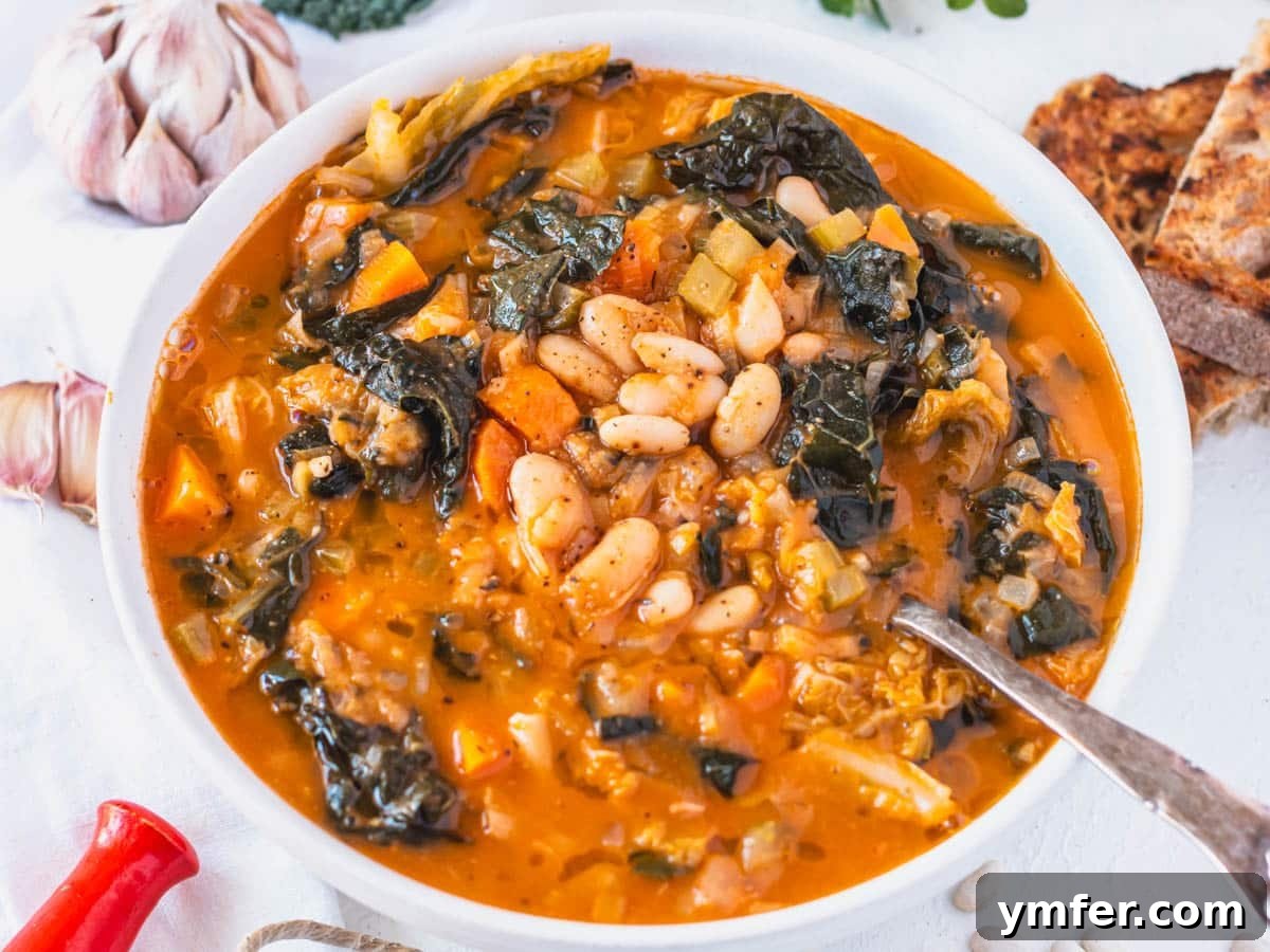 45 Effortless Vegetarian Dinner Ideas 13 Tuscan white bean soup with silver spoon and garlic cloves on the side