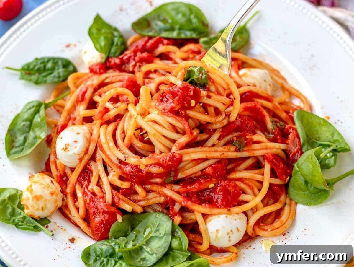 45 Effortless Vegetarian Dinner Ideas 5 pomodoro pasta with a fork and mozzarella balls
