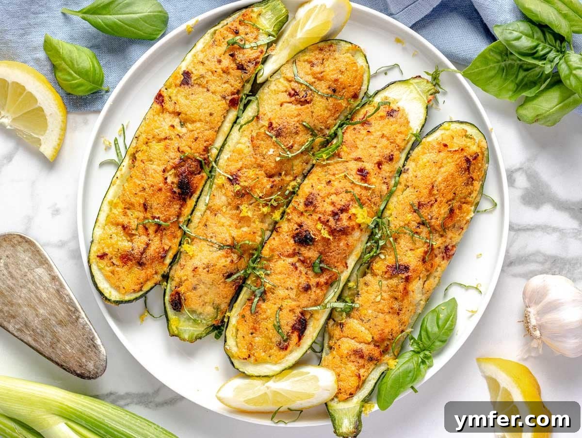45 Effortless Vegetarian Dinner Ideas 44 stuffed zucchini on a white plate with fresh herbs and lemon on the side