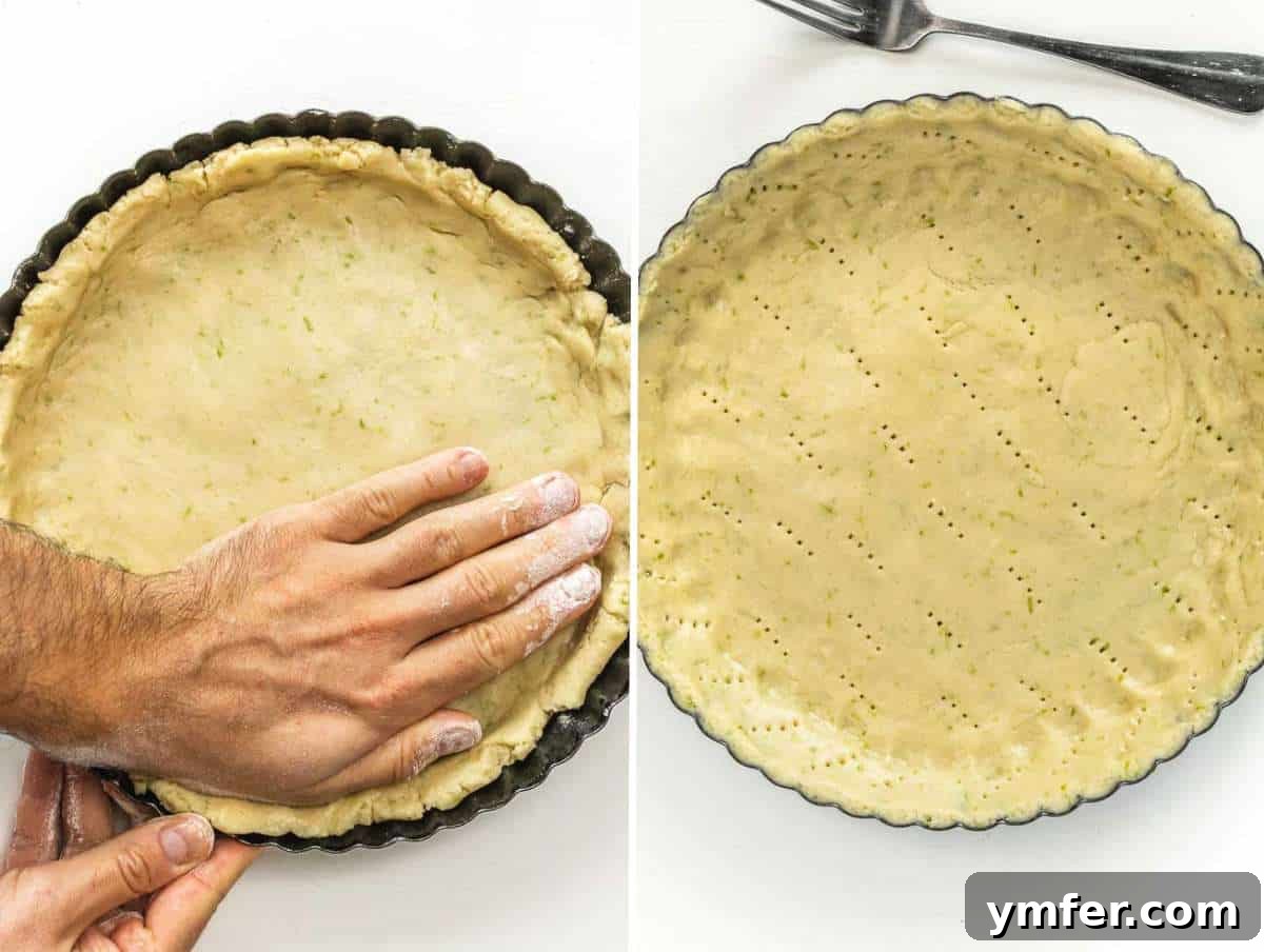 Hands shaping the tart dough evenly across the bottom and up the sides of the tart pan.
