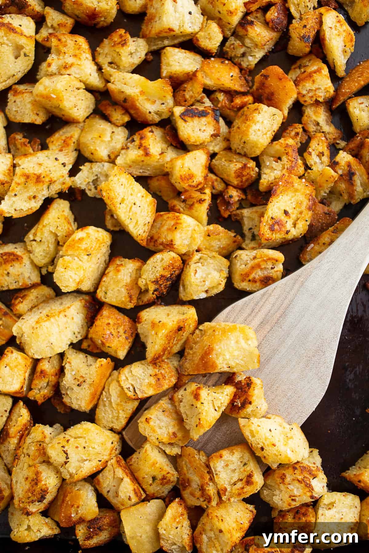 Golden Garlic Butter Croutons 3 Golden brown garlic butter croutons cooling on a baking pan after being perfectly toasted in the oven.