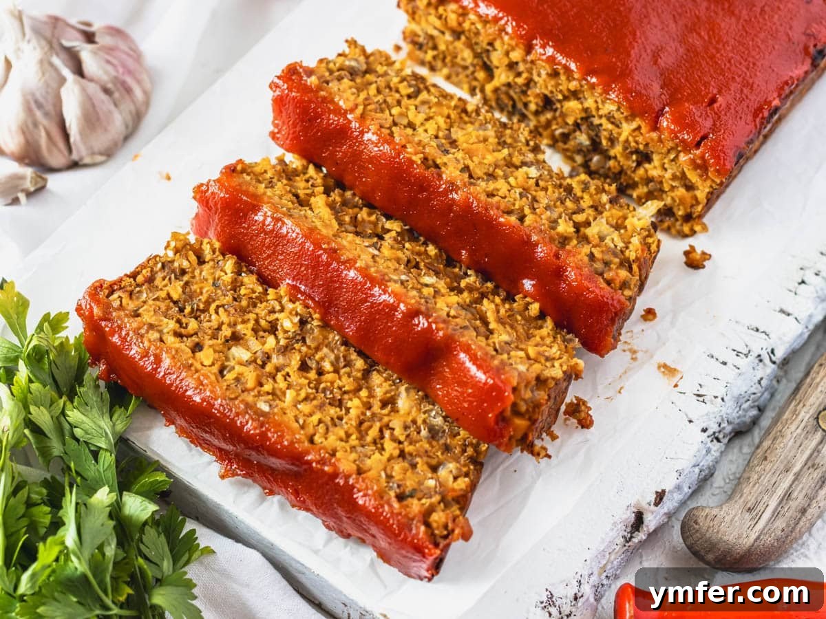 40 Flavorful Plant-Based Dinners 5 Lentil loaf served in hearty slices on a rustic cutting board.