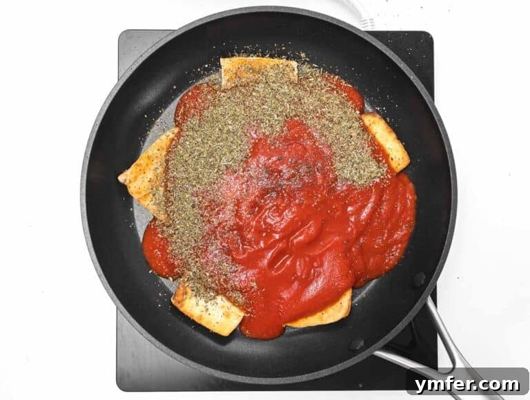 40 Flavorful Plant-Based Dinners 44 Tomato puree and oregano being added to the pan with tofu.