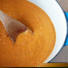 Golden Roasted Carrot Bisque 2 A vibrant bowl of creamy roasted carrot soup, garnished with fresh herbs, ready to be enjoyed.