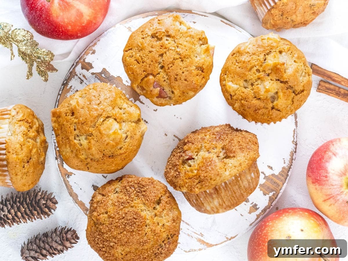 Cinnamon Apple Vegan Muffins 11 A stack of baked vegan apple muffins on a cooling rack