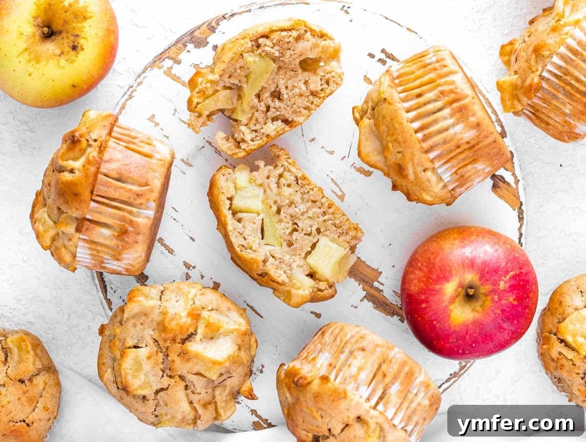 Cinnamon Apple Vegan Muffins 3 A cut-open apple muffin revealing moist interior with chunks and grated pieces of apple