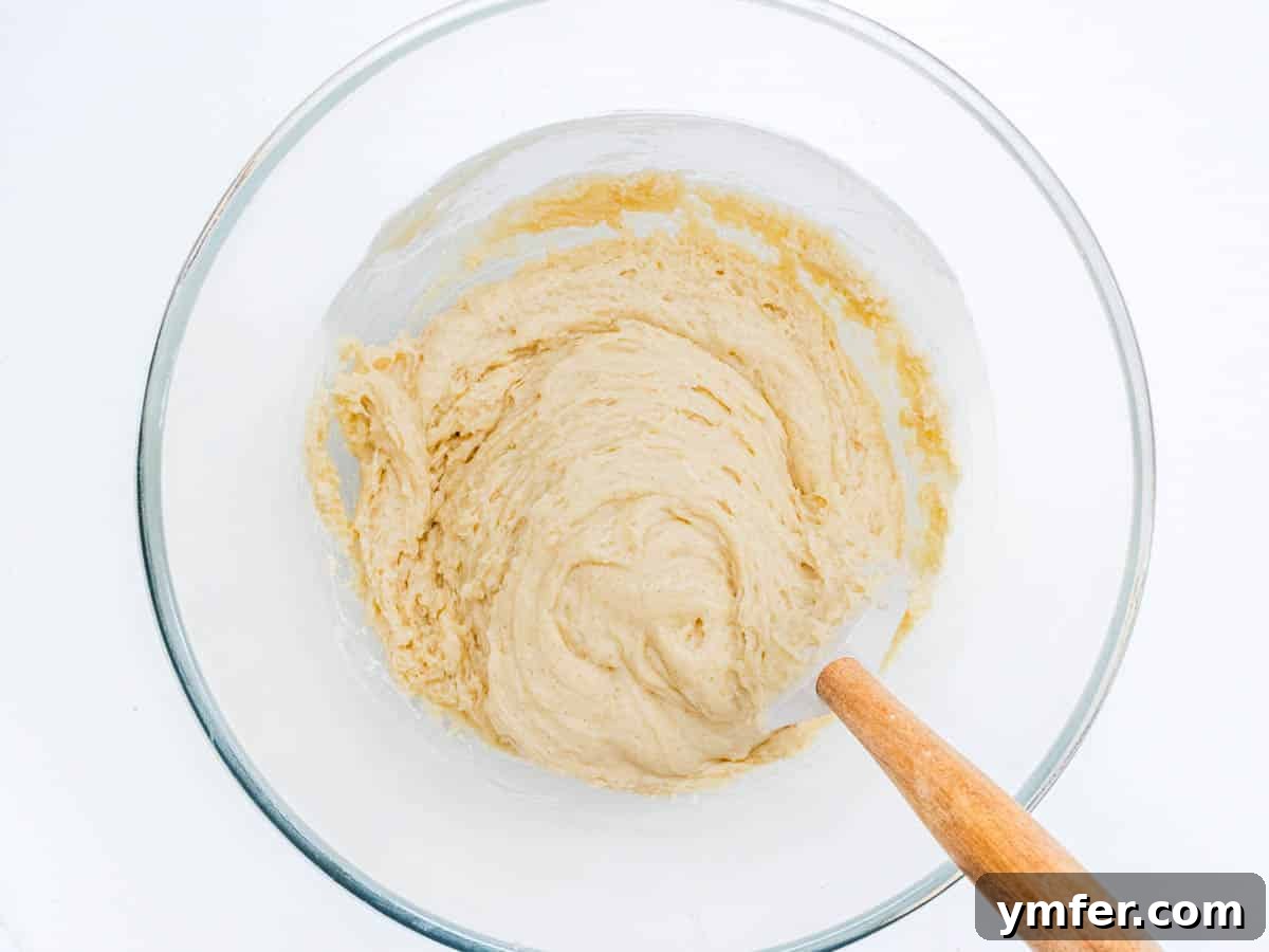 Cinnamon Apple Vegan Muffins 7 Muffin batter with wet and dry ingredients mixed, showing a slightly lumpy consistency