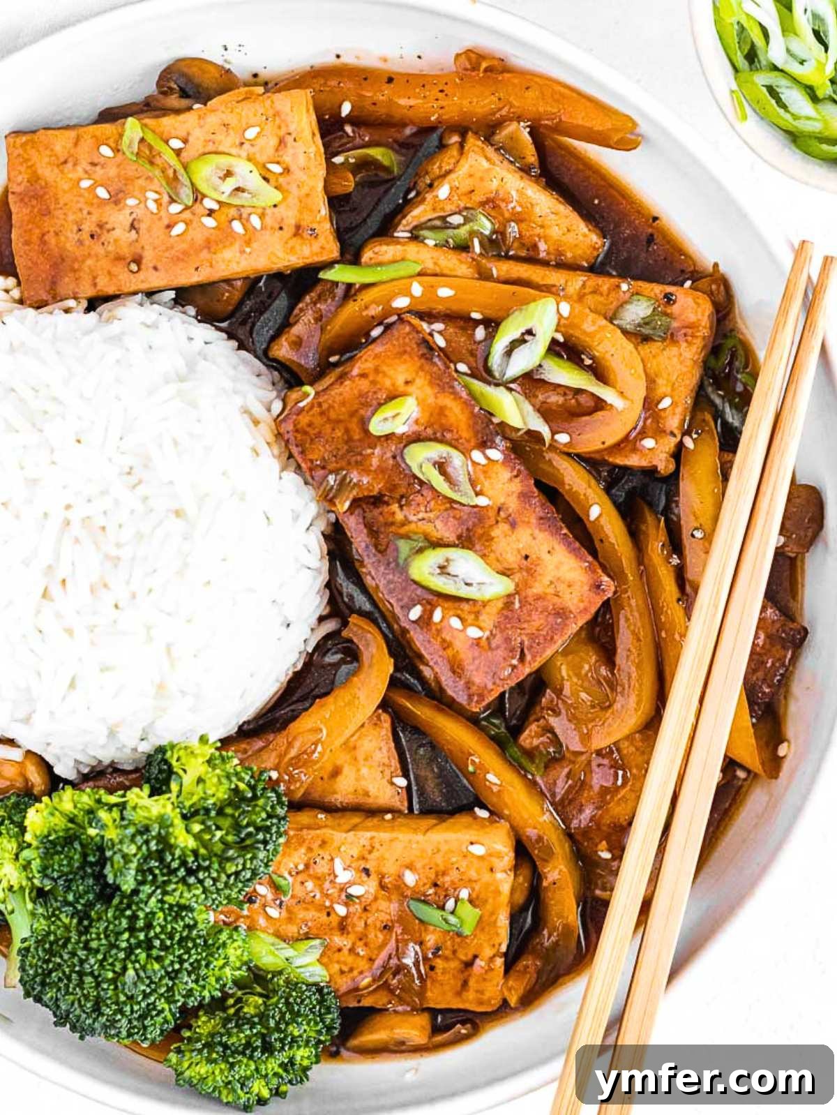 Umami Braised Tofu 2 braised tofu with basmati rice and chopsticks.