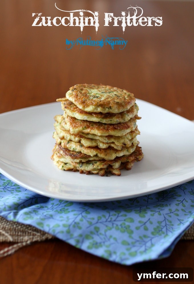 Delicious Zucchini Fritters Golden brown zucchini fritters stacked on a plate, garnished with fresh herbs, ready to be served as an appetizer or light meal.