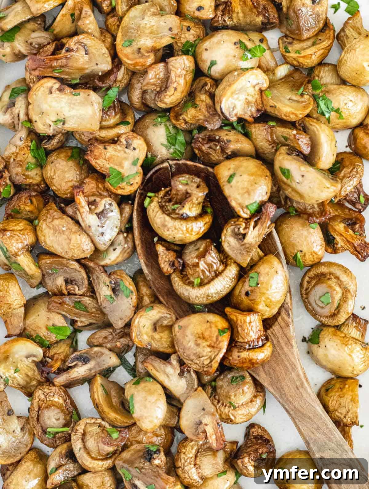 Crispy Air-Fried Mushrooms 2 Close-up of golden brown air-fried mushrooms, garnished with fresh parsley.