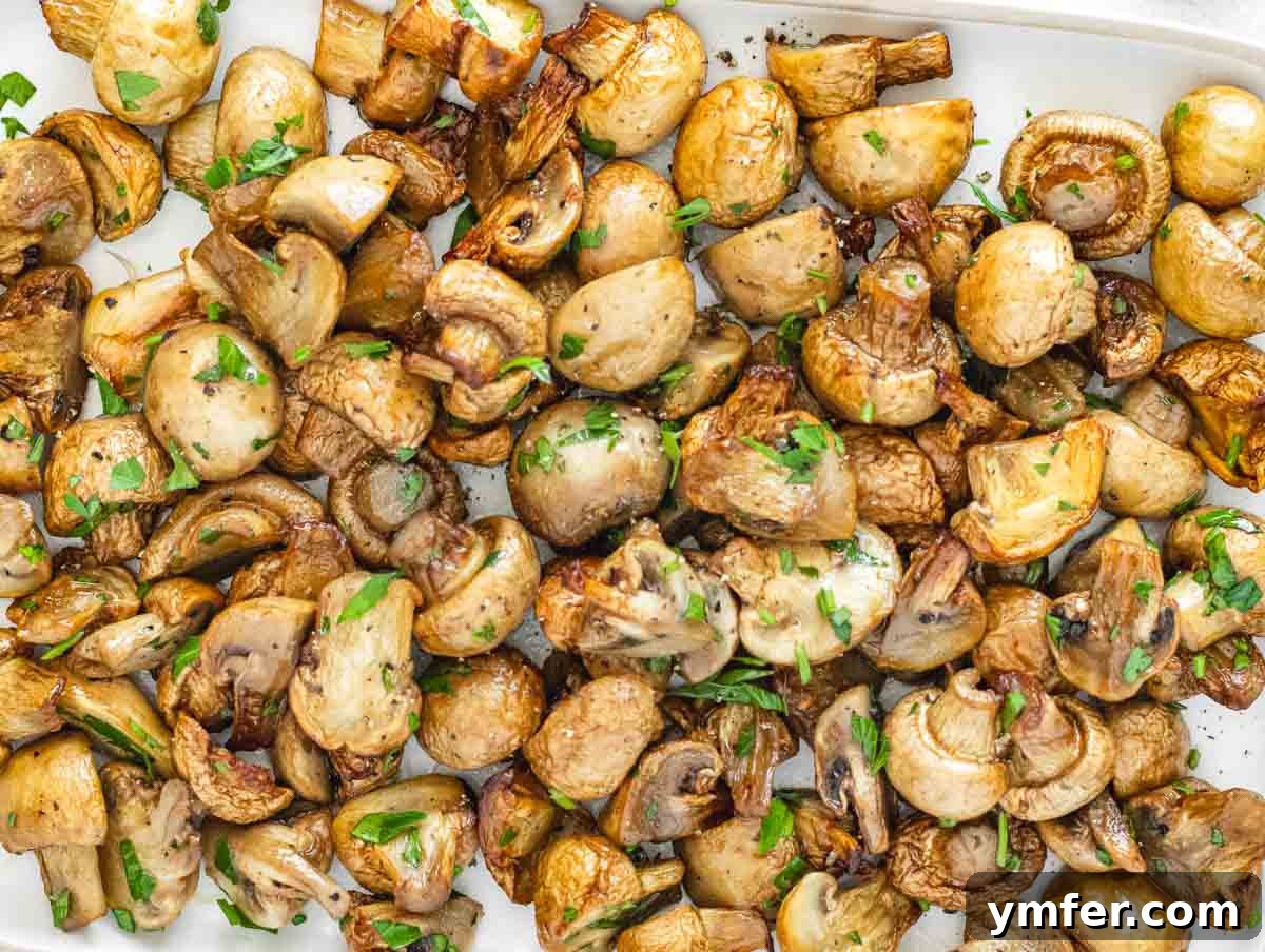 Crispy Air-Fried Mushrooms 3 Air fryer mushrooms garnished with fresh parsley on a white plate, ready to serve.