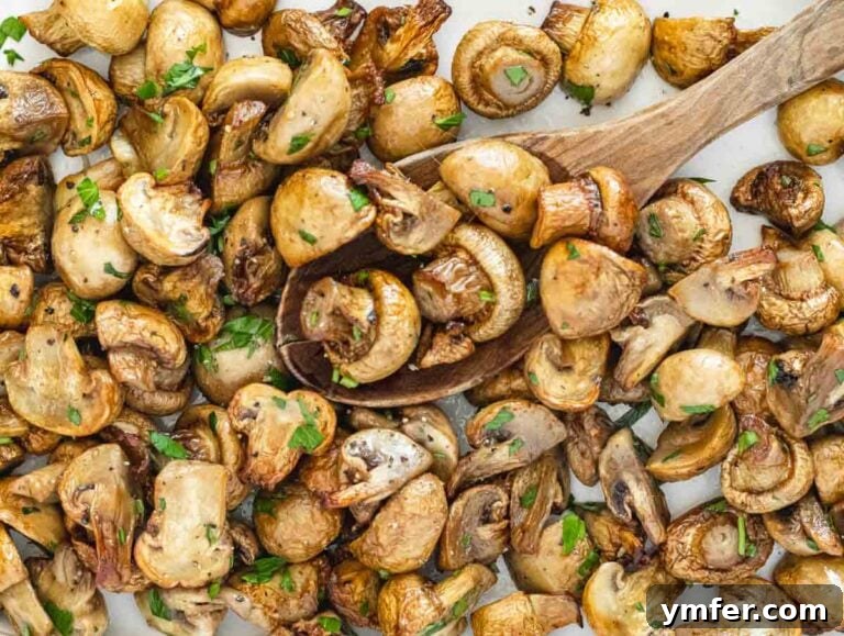 Crispy Air-Fried Mushrooms 8 Air-fried mushrooms served on a white plate with a wooden spoon and fresh parsley.