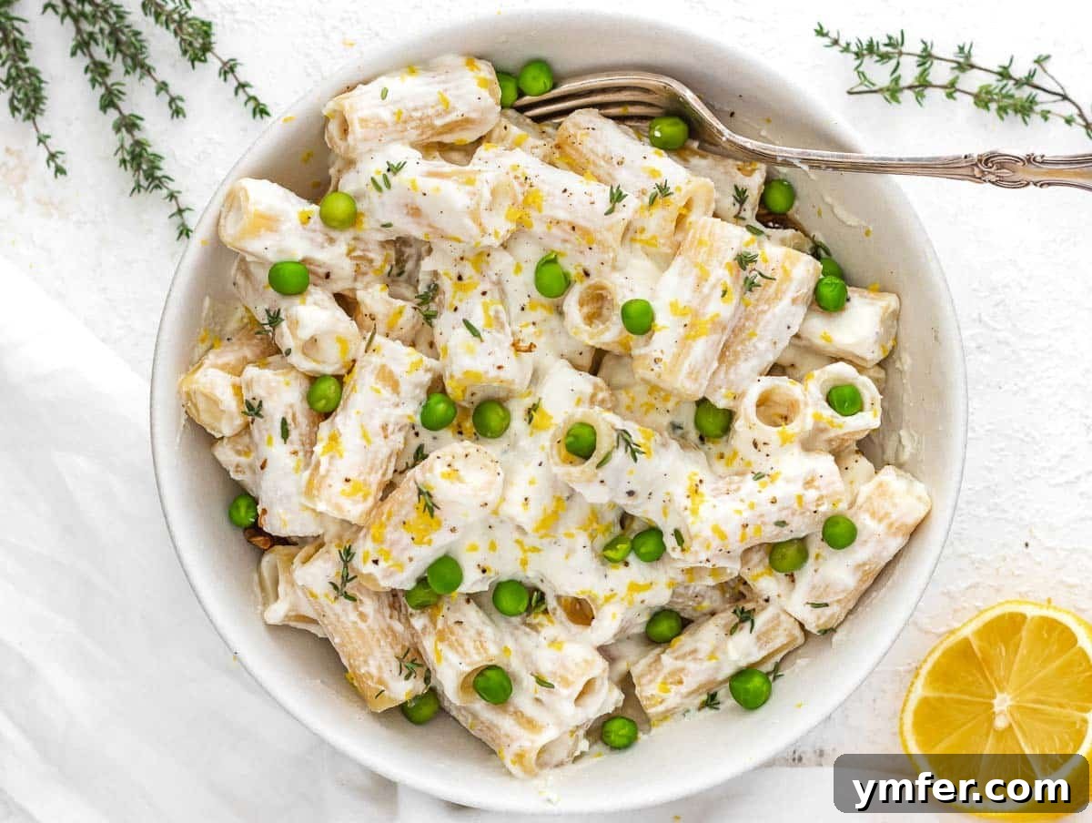 Zesty Lemon Ricotta Pasta 7 A bowl of lemon ricotta pasta featuring various colorful vegetable additions as suggested variations.