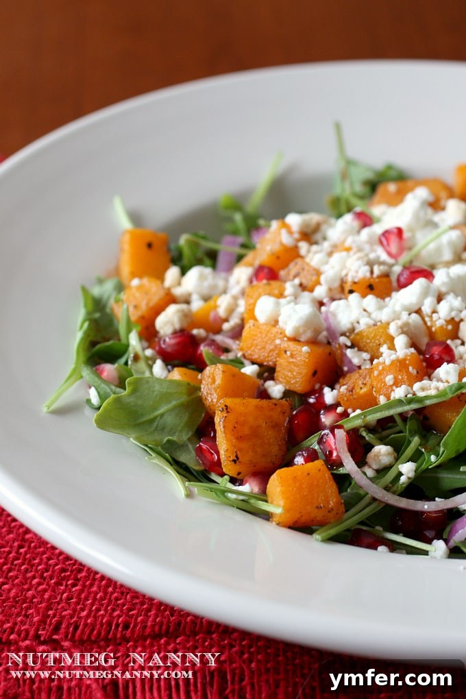 Healthy and Delicious Butternut Squash Salad Butternut Squash Salad in a pristine white bowl, showcasing fresh ingredients.