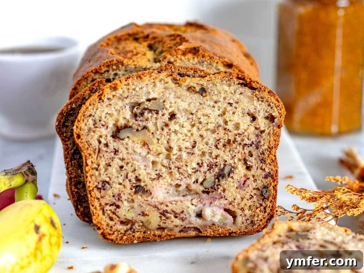 Homemade Banana Walnut Bliss 6 Beautifully sliced banana nut bread resting on a pristine white cutting board, showcasing its moist interior.