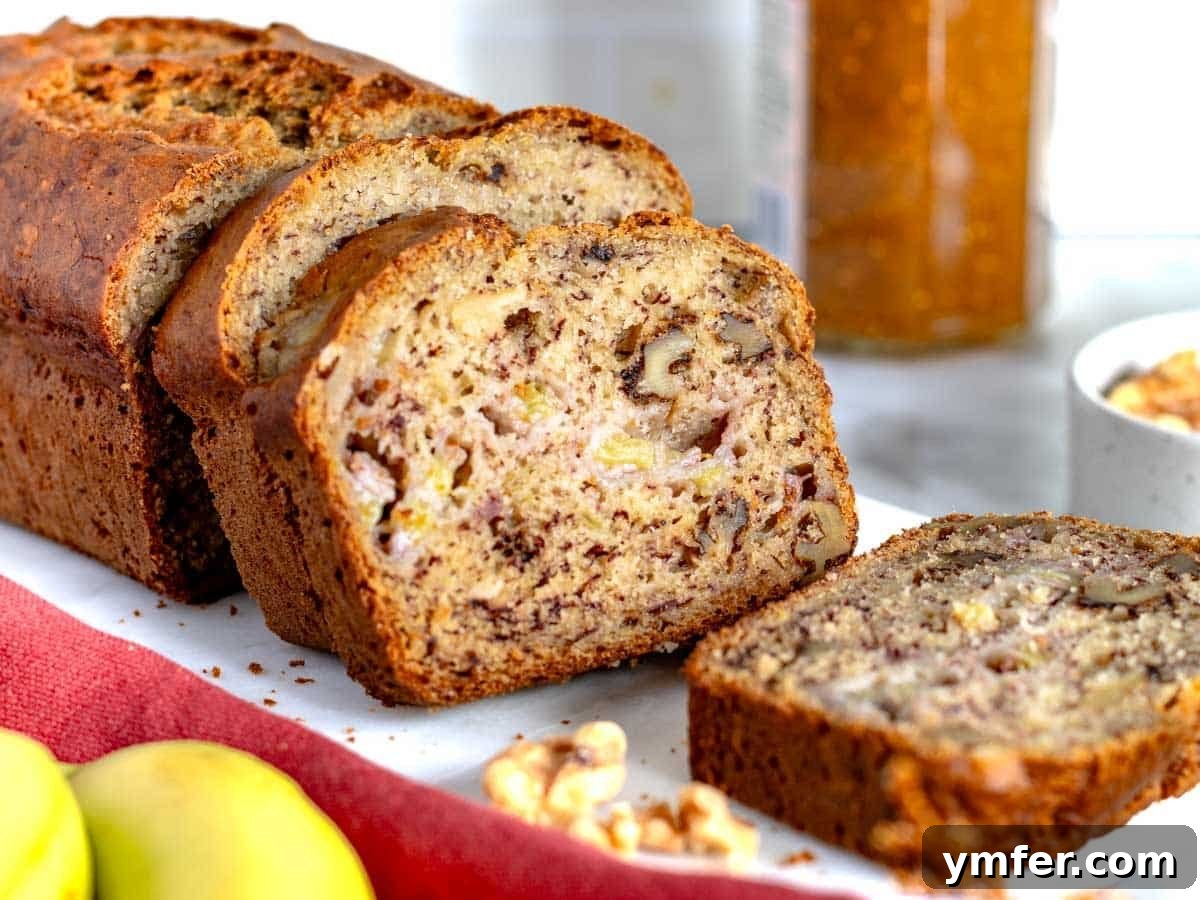 Homemade Banana Walnut Bliss 10 A tempting display of banana nut bread slices with scattered walnuts, ready for serving.
