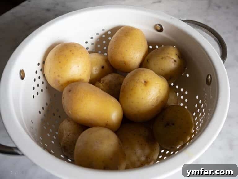 Velvety Garlic Potatoes 11 Boiled potatoes steaming off in a colander.