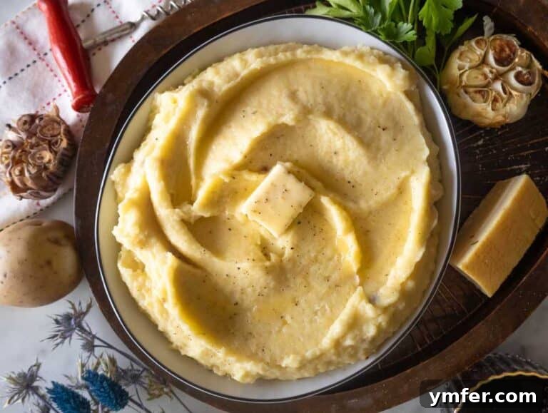 Velvety Garlic Potatoes 13 Garlic mashed potatoes in a bowl with butter.