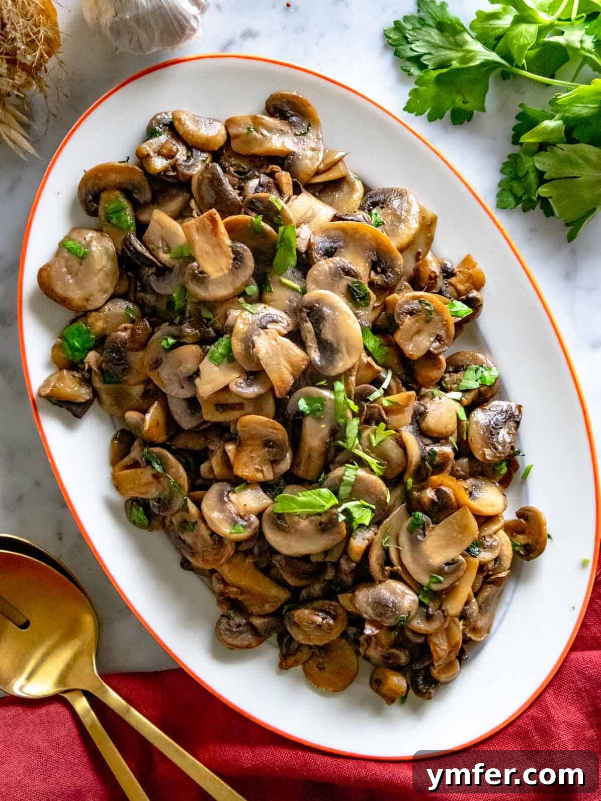 Golden Garlic Mushrooms 2 sauteed mushrooms on an oval platter with fresh parsley