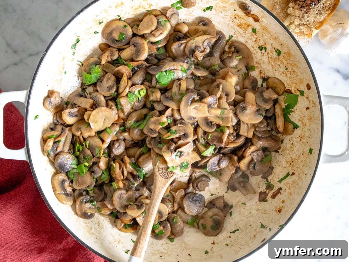 Golden Garlic Mushrooms 11 sauteed mushrooms with parsley in a white skillet