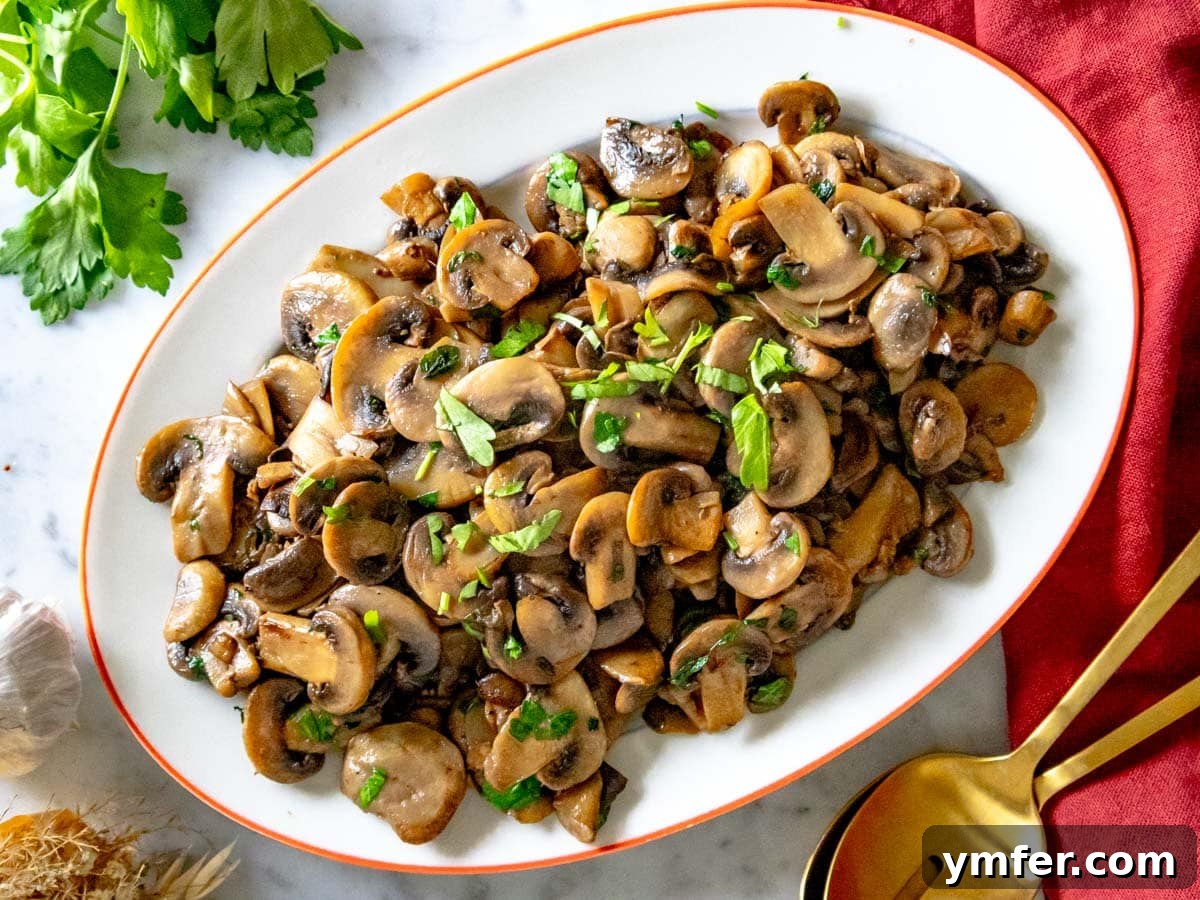 Golden Garlic Mushrooms 12 sauteed mushrooms on an oval platter and a red cloth