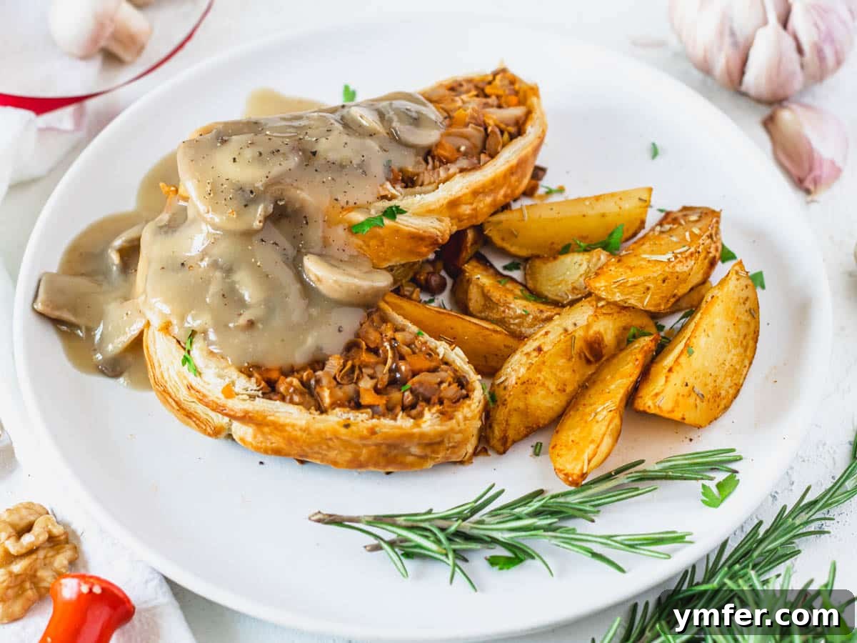 Golden Garlic Mushrooms 14 Mushroom wellington and gravy on a white plate