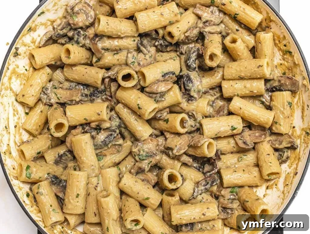 Hummus pasta in a skillet after being reheated.