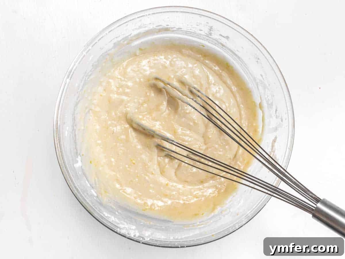 Muffin batter, showing it is just barely combined with some lumps.