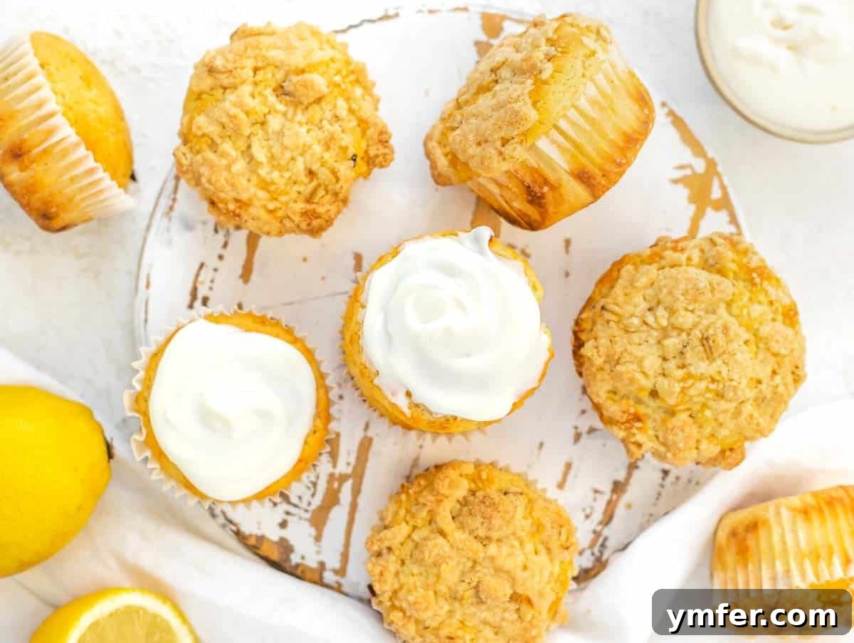 Lemon muffins adorned with a swirl of cream cheese topping.