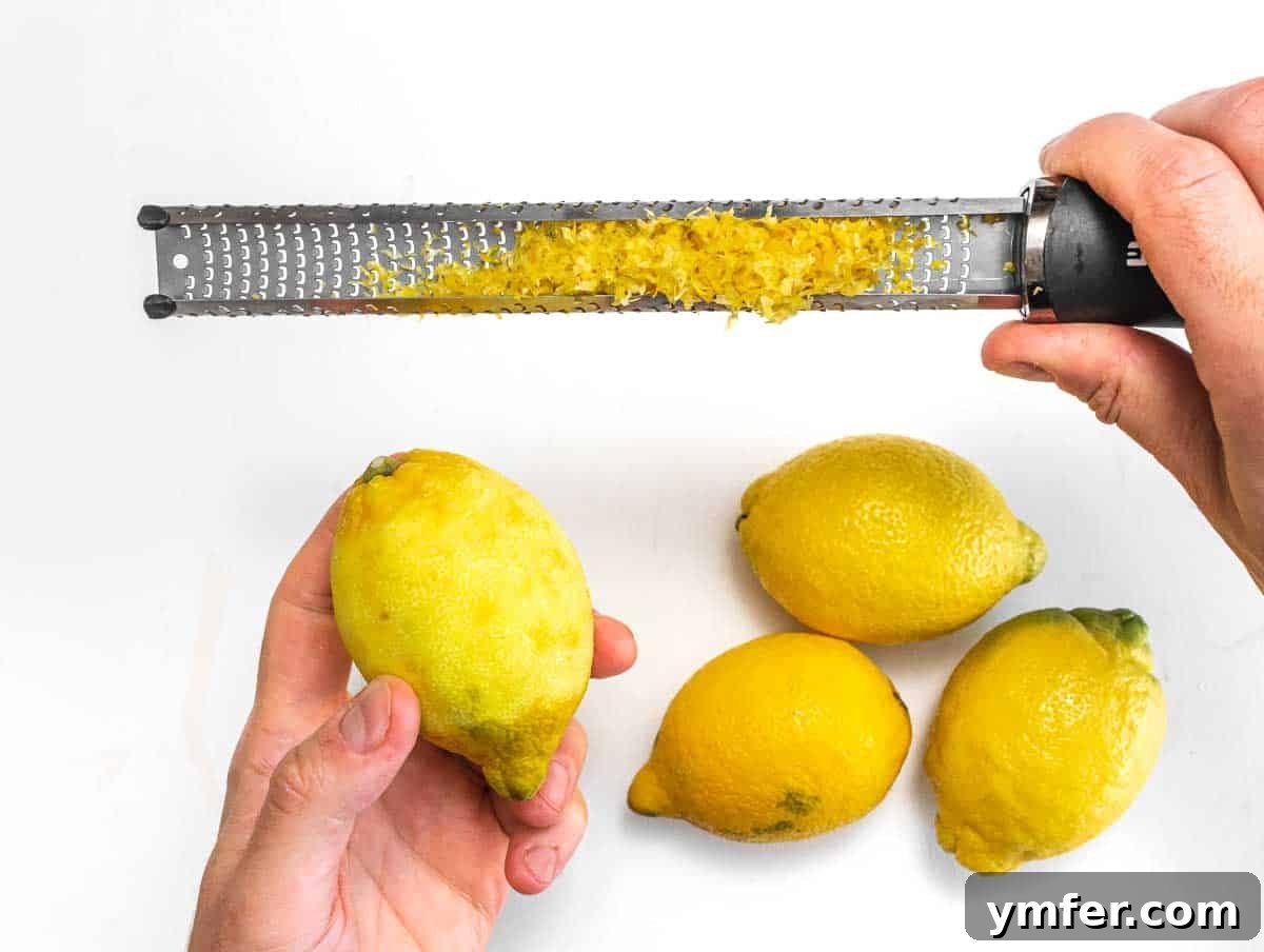 Freshly grated lemon zest and juice in a bowl.