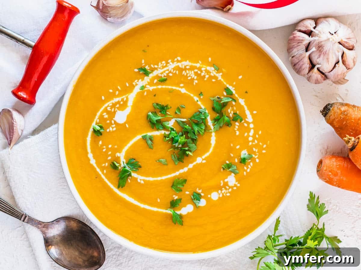 Golden Ginger Carrot Elixir 13 Carrot soup in a white bowl with parsley