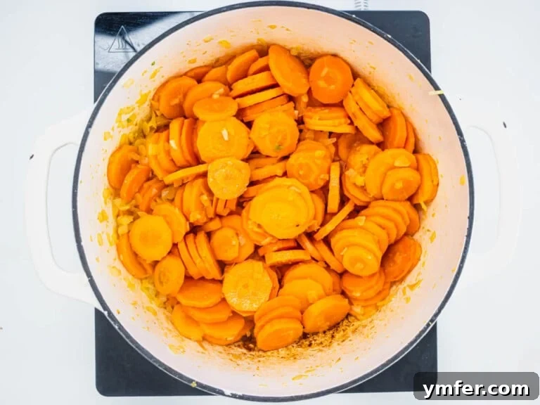 Golden Ginger Carrot Elixir 16 sliced carrots with flavor base in a white casserole