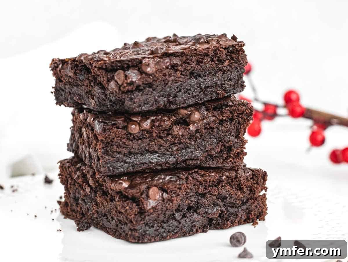 Decadent Plant-Based Brownies 16 Vegan brownies stacked on white plate