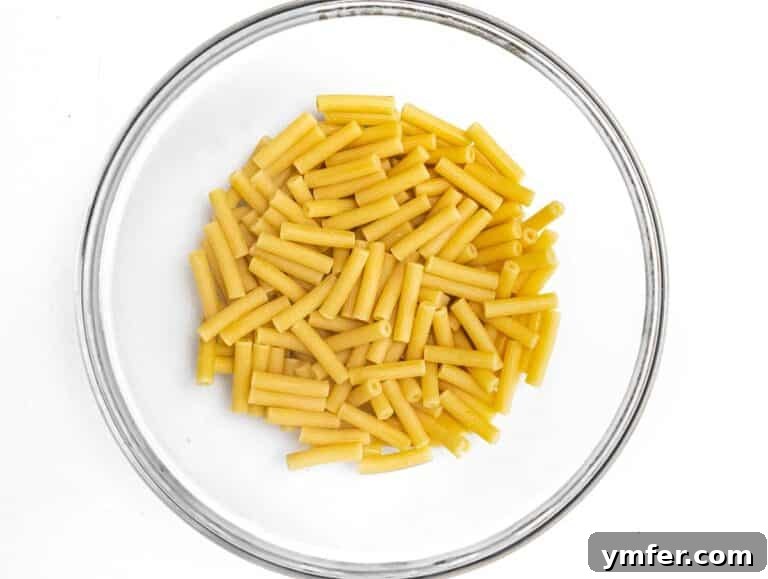 Golden Harvest Pumpkin Pasta 19 Ziti pasta in a large mixing bowl after being cooked al dente.